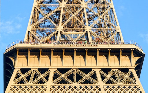 Eiffel Tower viewing platform with visitors during guided elevator tour in Paris.