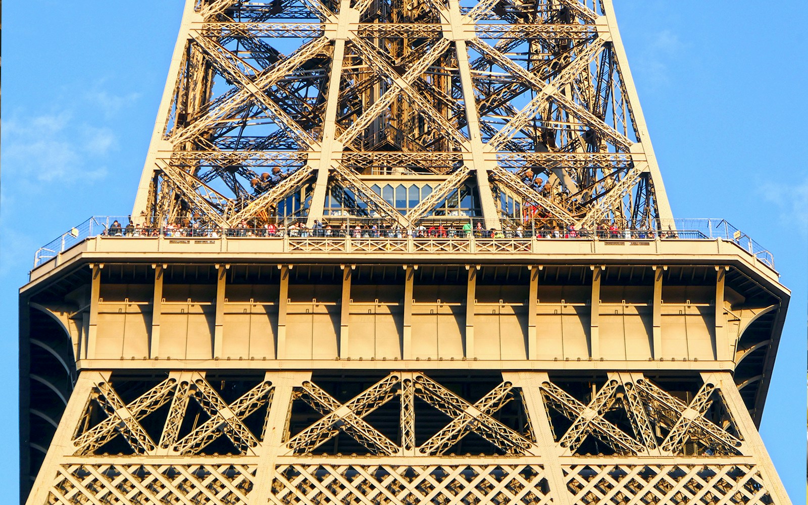 Eiffel Tower viewing platform with visitors during guided elevator tour in Paris.