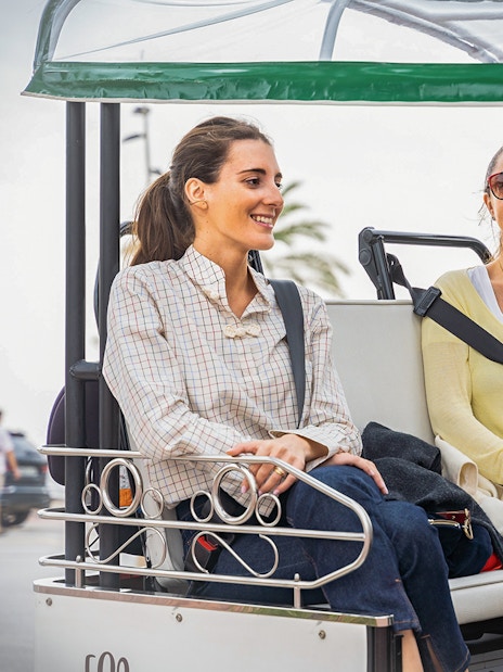 Tourists enjoying a tuk tuk ride in Barcelona.