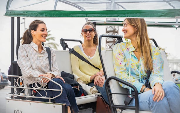 Tourists enjoying a tuk tuk ride in Barcelona.