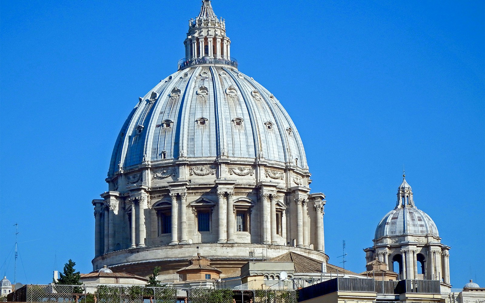 St. Peter's Basilica exterior view in Vatican City, showcasing its iconic dome and architectural details.