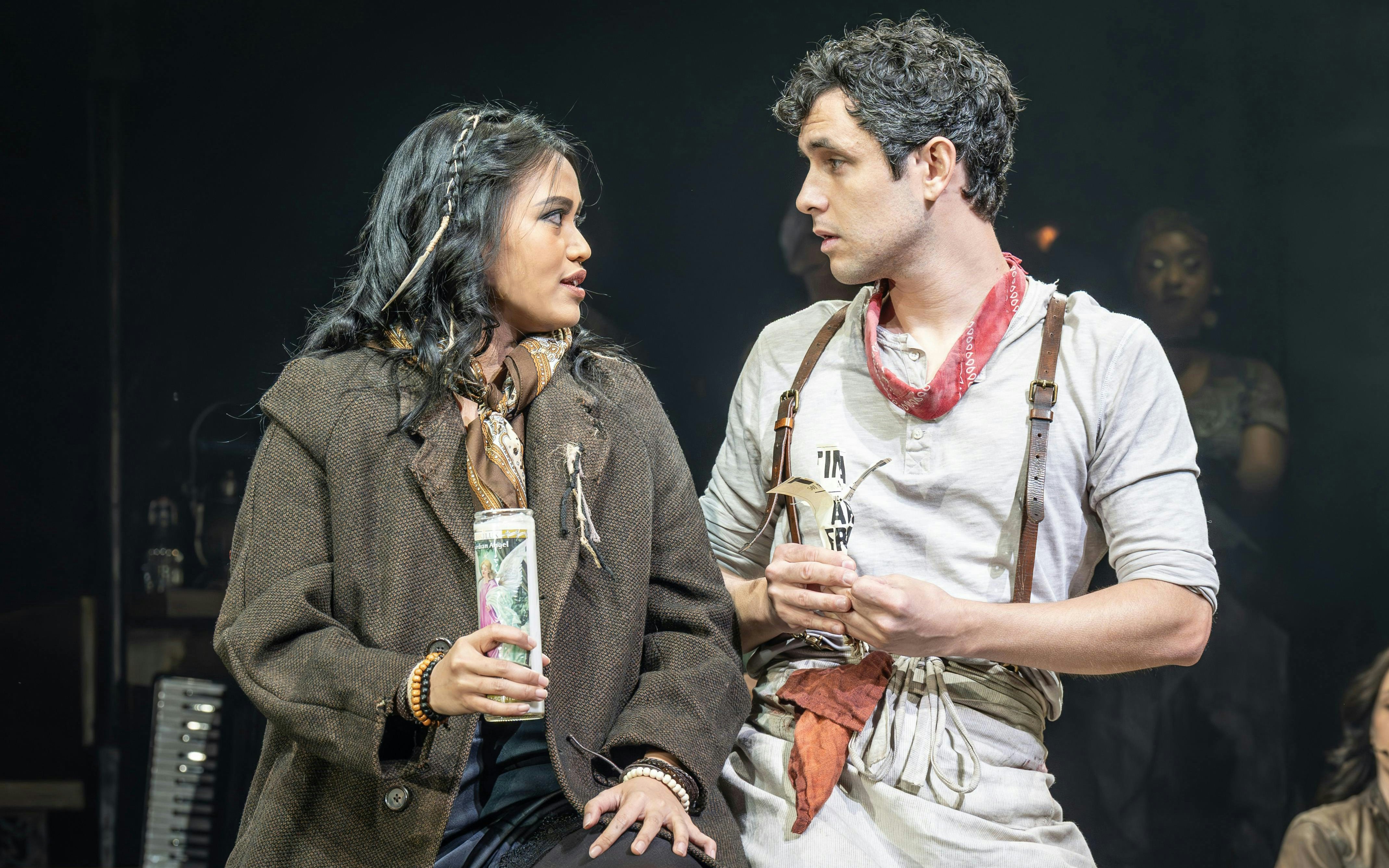 Actors performing a scene from Hadestown on West End stage.