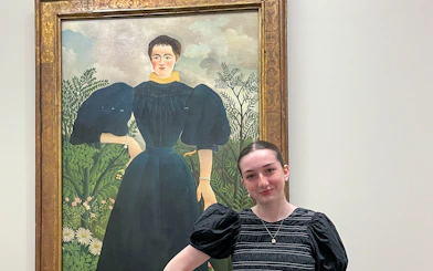 Painting at Orangerie Museum with visitor standing nearby.