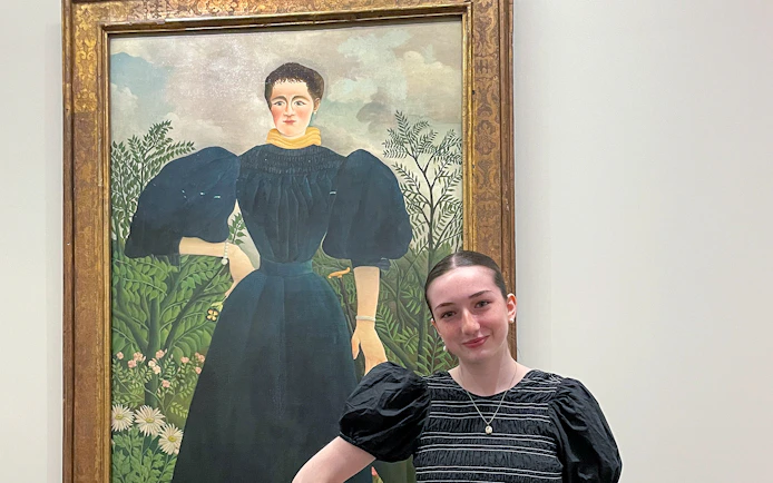 Painting at Orangerie Museum with visitor standing nearby.