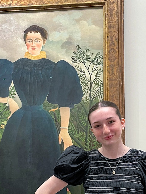 Painting at Orangerie Museum with visitor standing nearby.