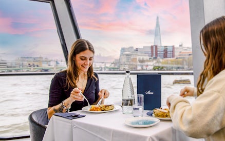 Dining on Thames River cruise with view of The Shard in London.