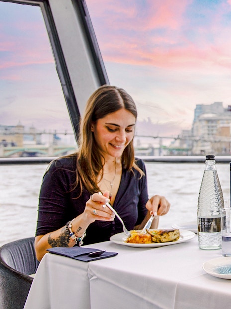 Dining on Thames River cruise with view of The Shard in London.