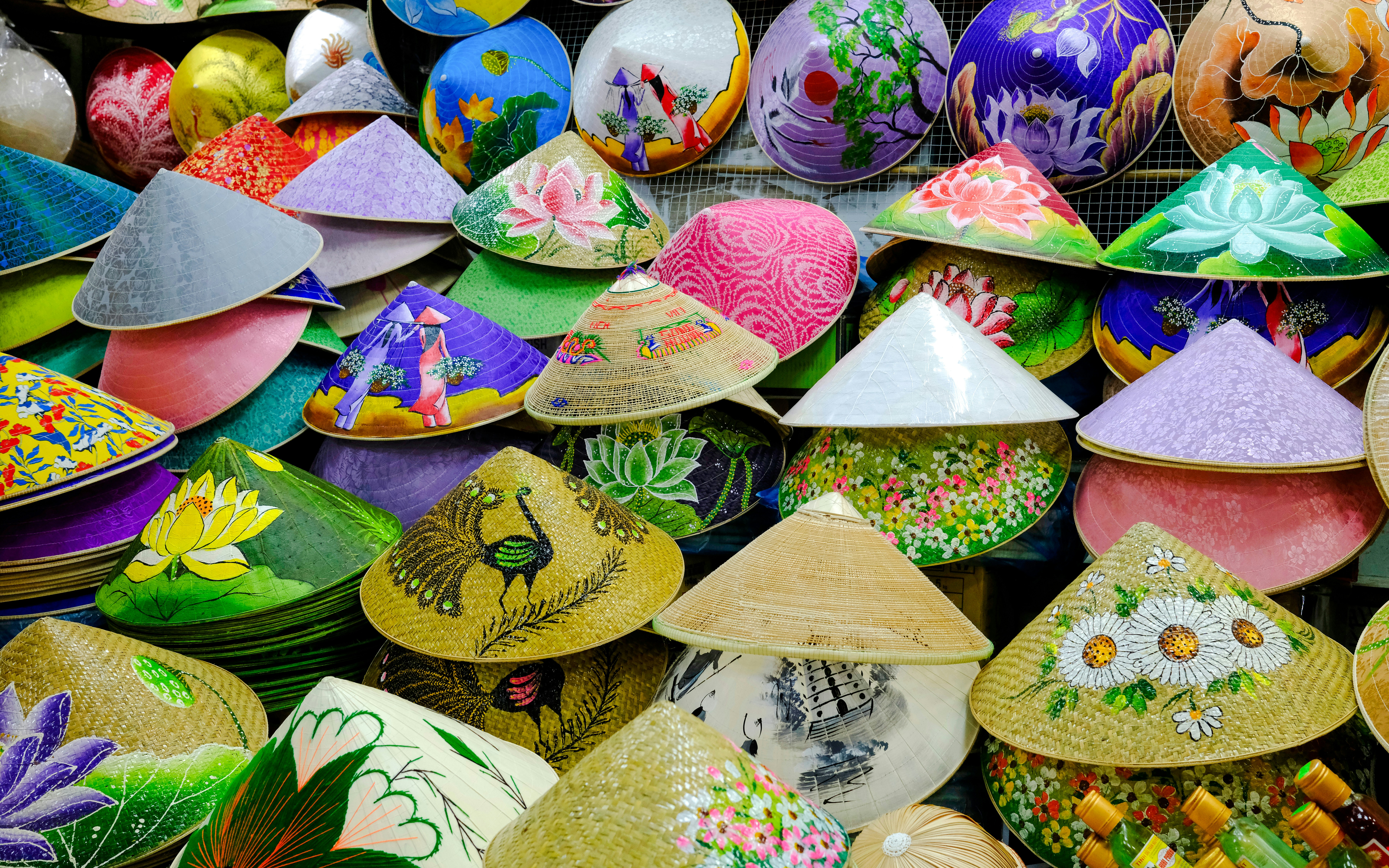 Colorful conical hats with floral and scenic designs at Dong Ba Market, Hue, Vietnam.