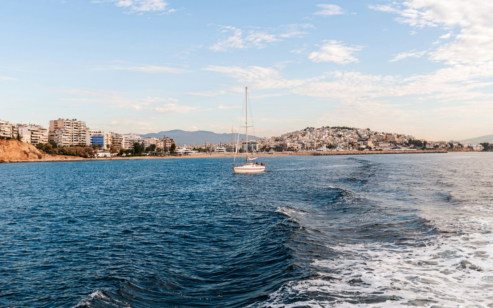 Piraeus port city view with boats docked in Saronic Gulf, Athens, Greece.