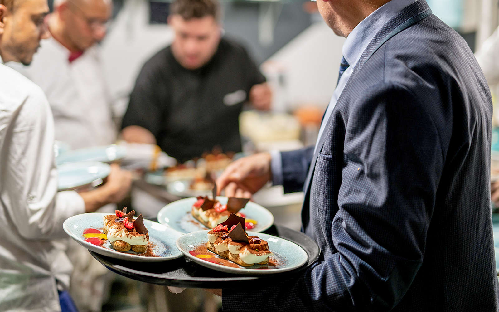 Servers preparing Italian desserts on Le Diamant Bleu dinner cruise in Paris.