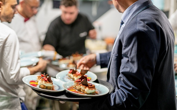 Servers preparing Italian desserts on Le Diamant Bleu dinner cruise in Paris.