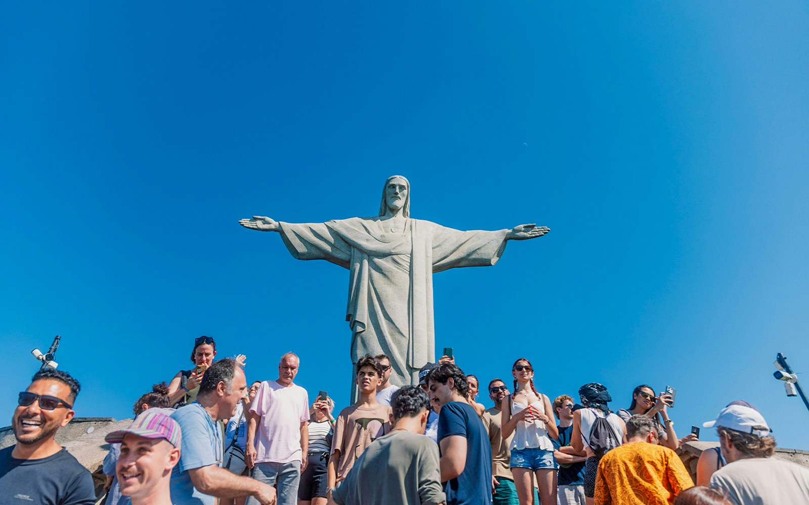 Tourists at the base of Christ the Redeemer statue in Rio de Janeiro, Brazil.
