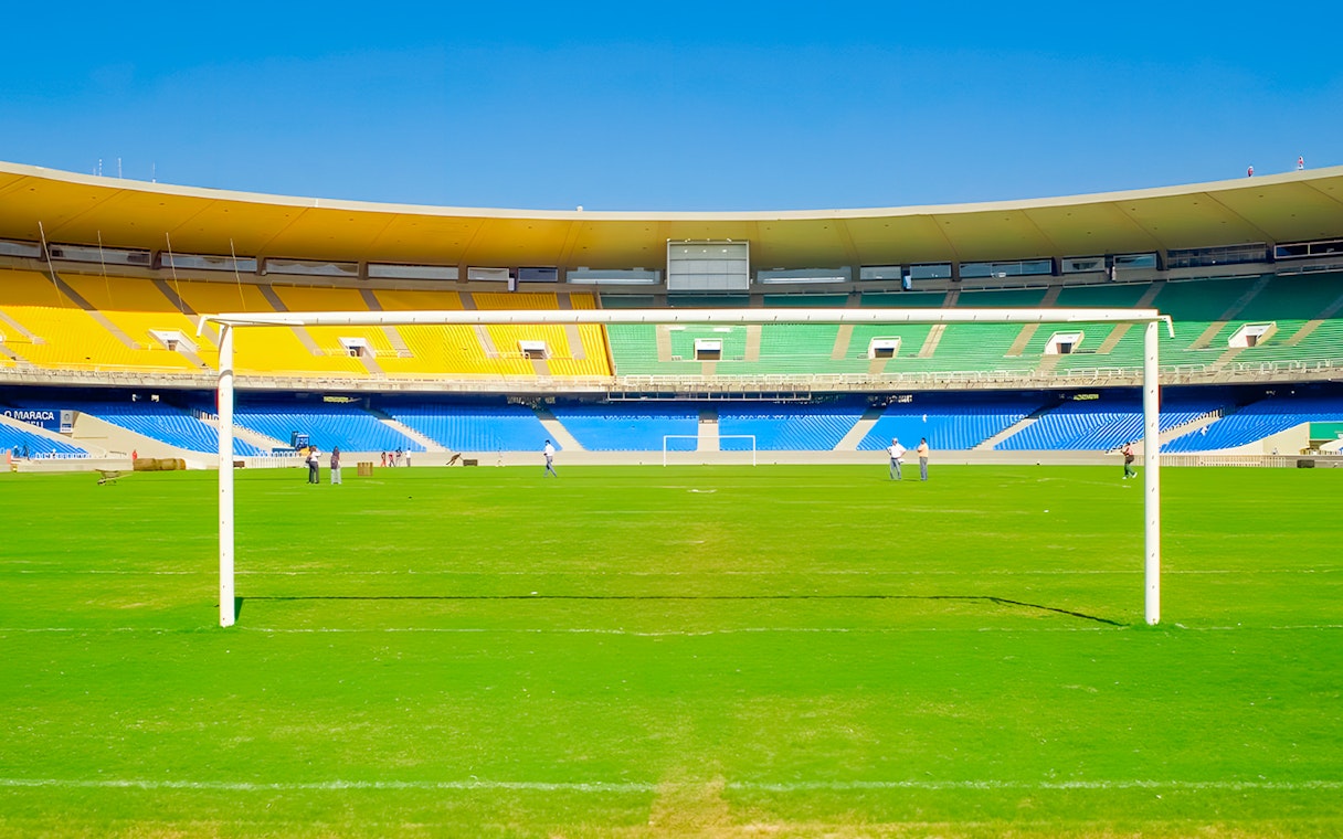 Maracanã Stadium field with goalposts and colorful seating, Rio de Janeiro, Brazil.