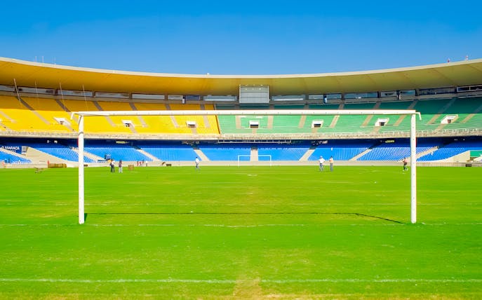 Maracanã Stadium field with goalposts and colorful seating, Rio de Janeiro, Brazil.