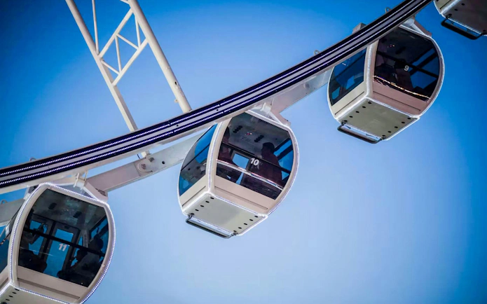 Asiatique Sky Ferris wheel cabins against blue sky, Bangkok, Thailand.