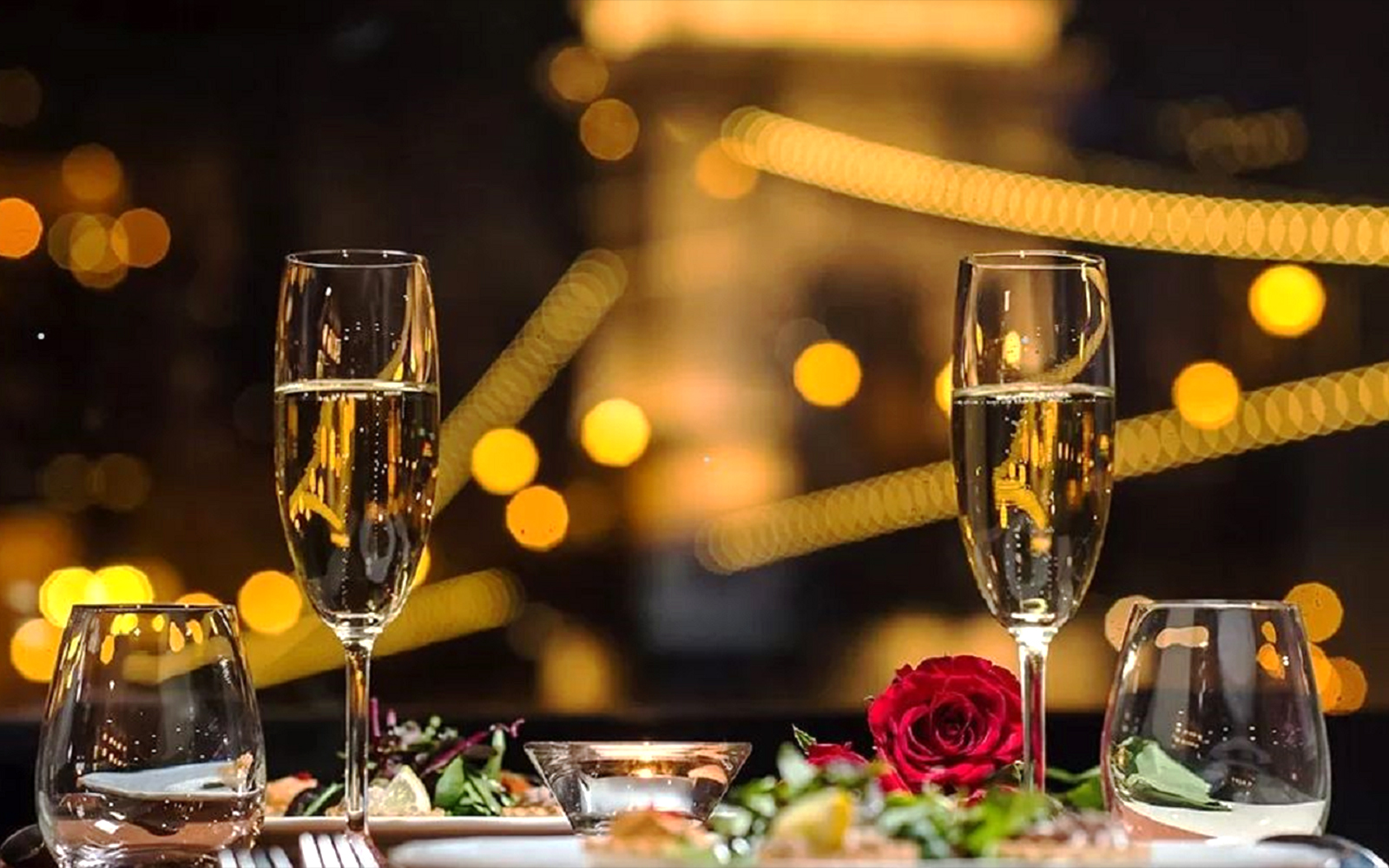 Champagne glasses and candlelit dinner setting on Budapest Christmas cruise.