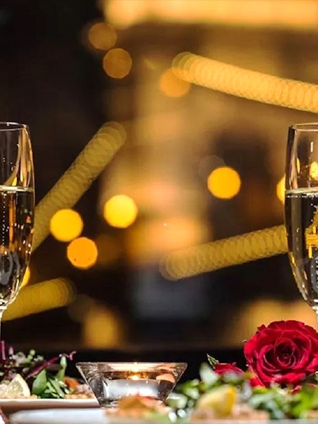 Champagne glasses and candlelit dinner setting on Budapest Christmas cruise.