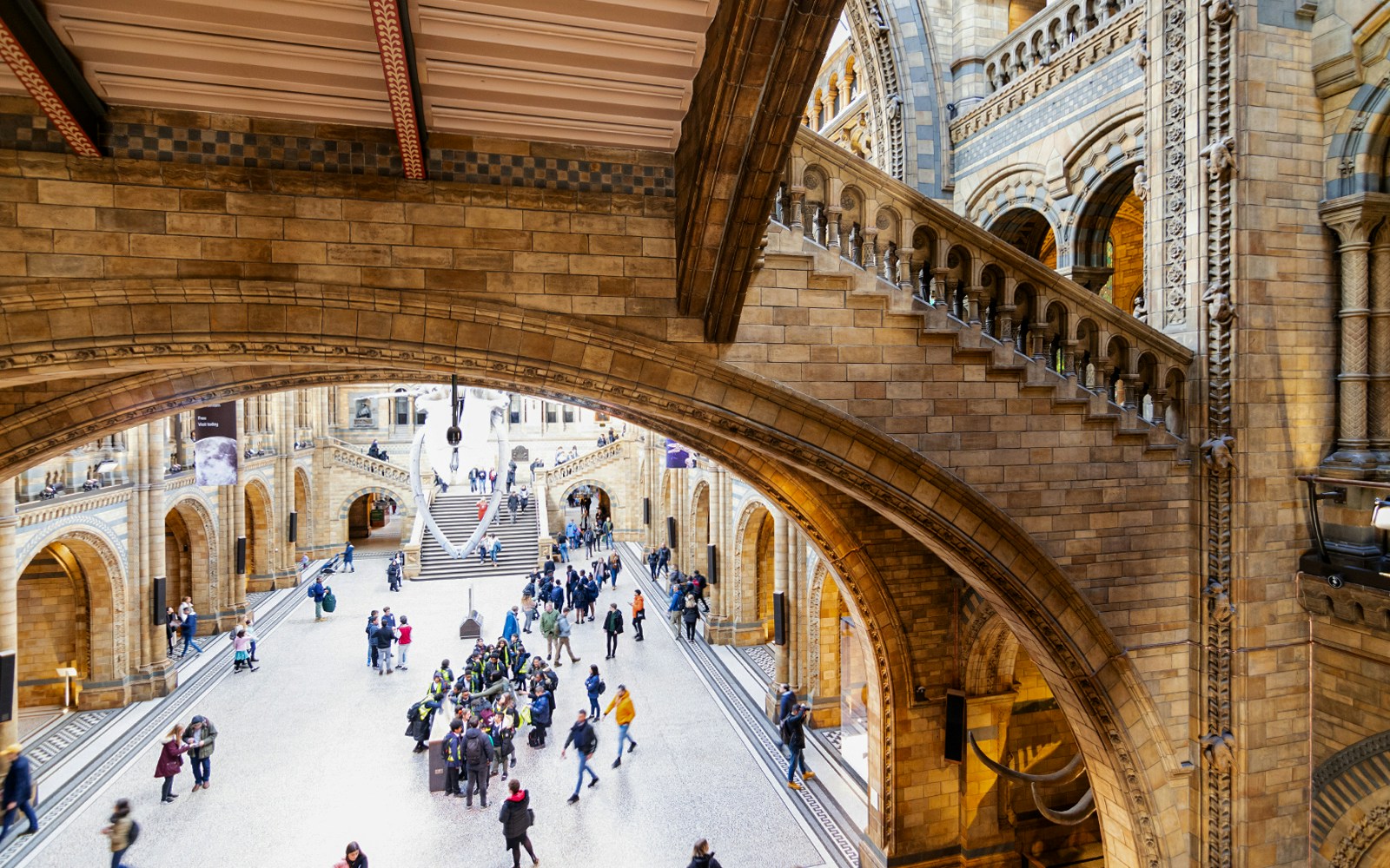 Visitors exploring the grand hall of the Natural History Museum, London.