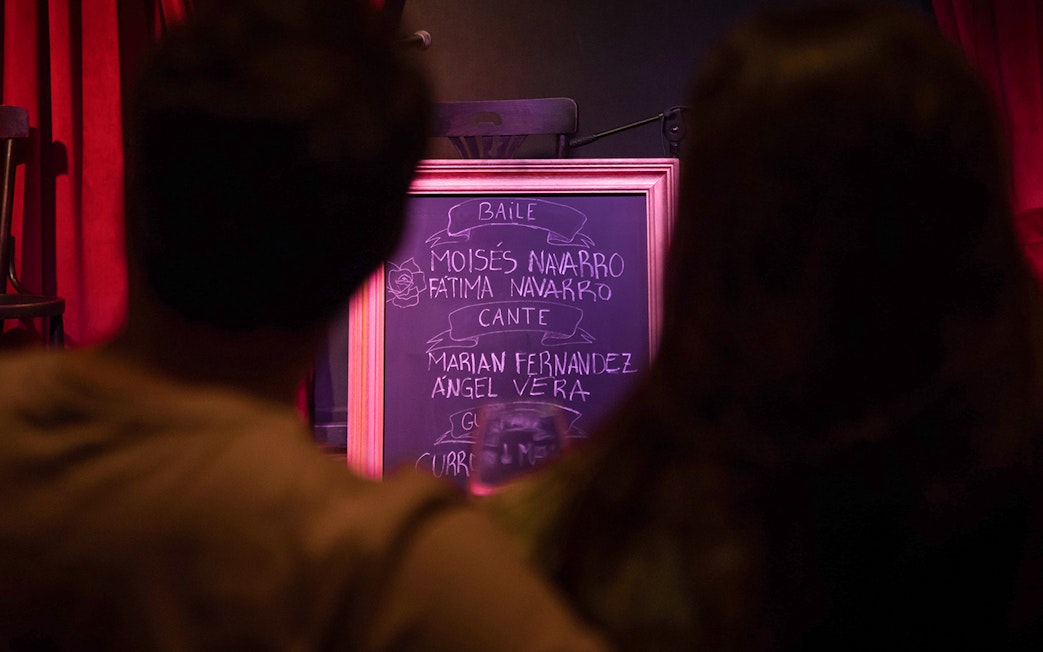 Chalkboard listing performers at Alegría Flamenco & Gastronomia event.