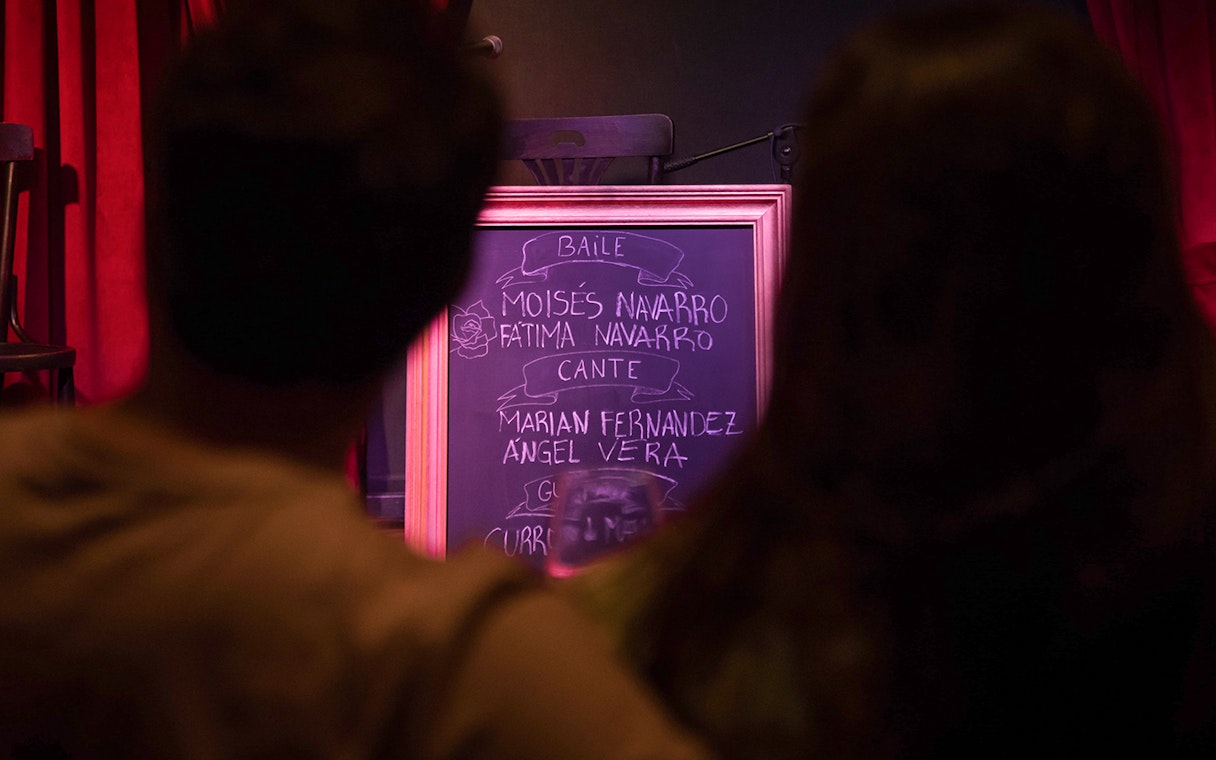 Chalkboard listing performers at Alegría Flamenco & Gastronomia event.