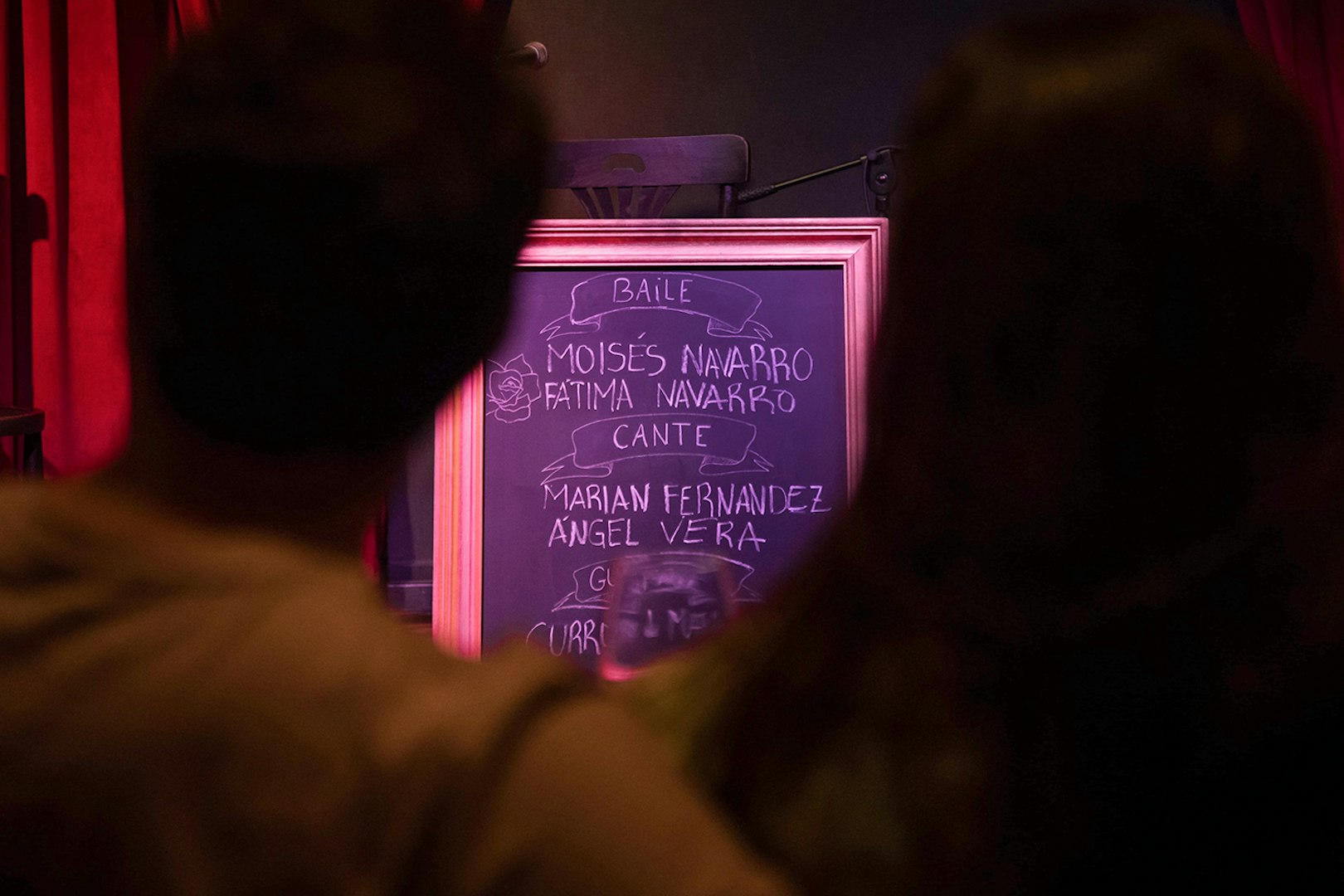 Chalkboard listing performers at Alegría Flamenco & Gastronomia event.