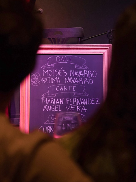 Chalkboard listing performers at Alegría Flamenco & Gastronomia event.
