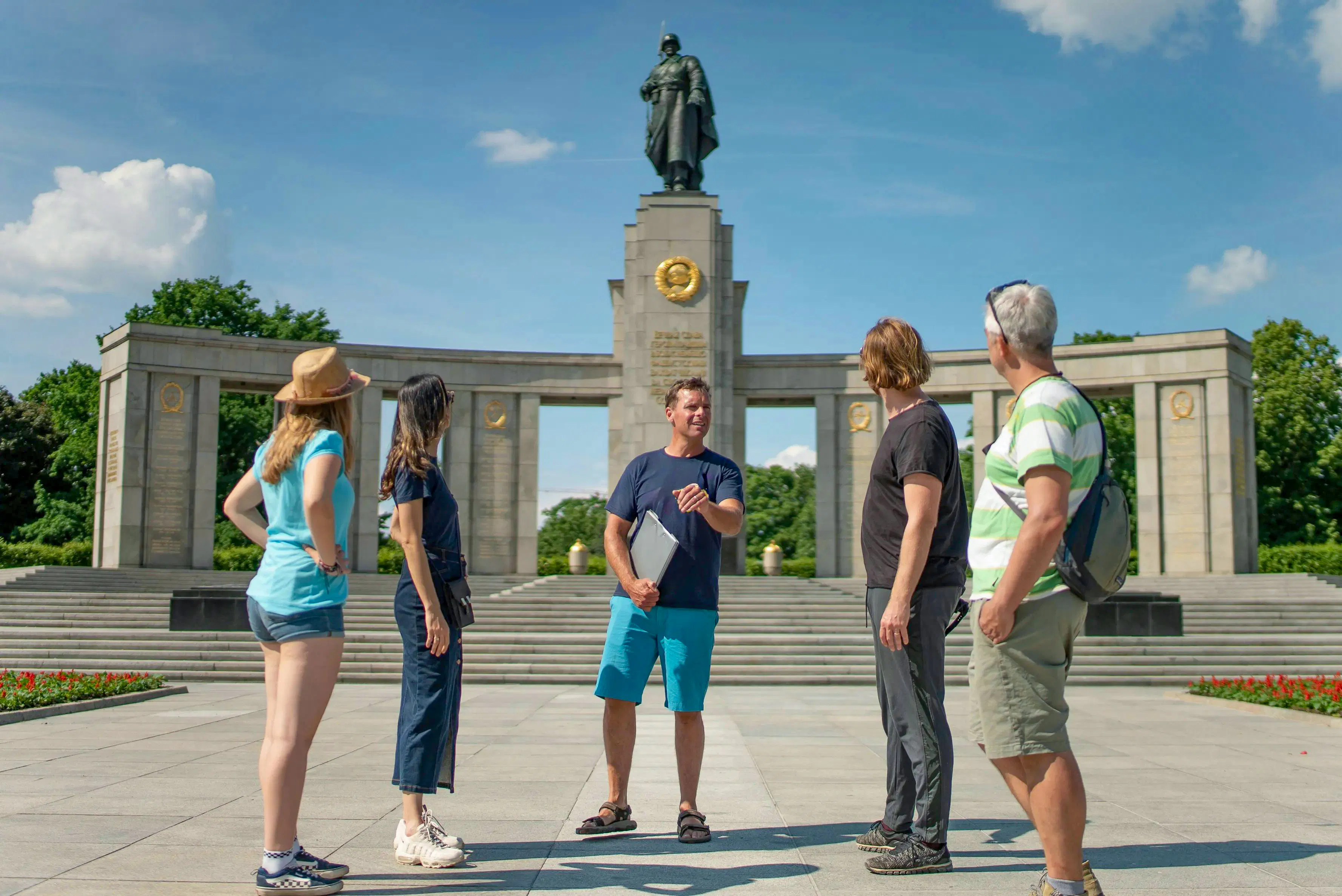 Tour group at Soviet Memorial in Tiergarten, Berlin, with guide explaining the monument.