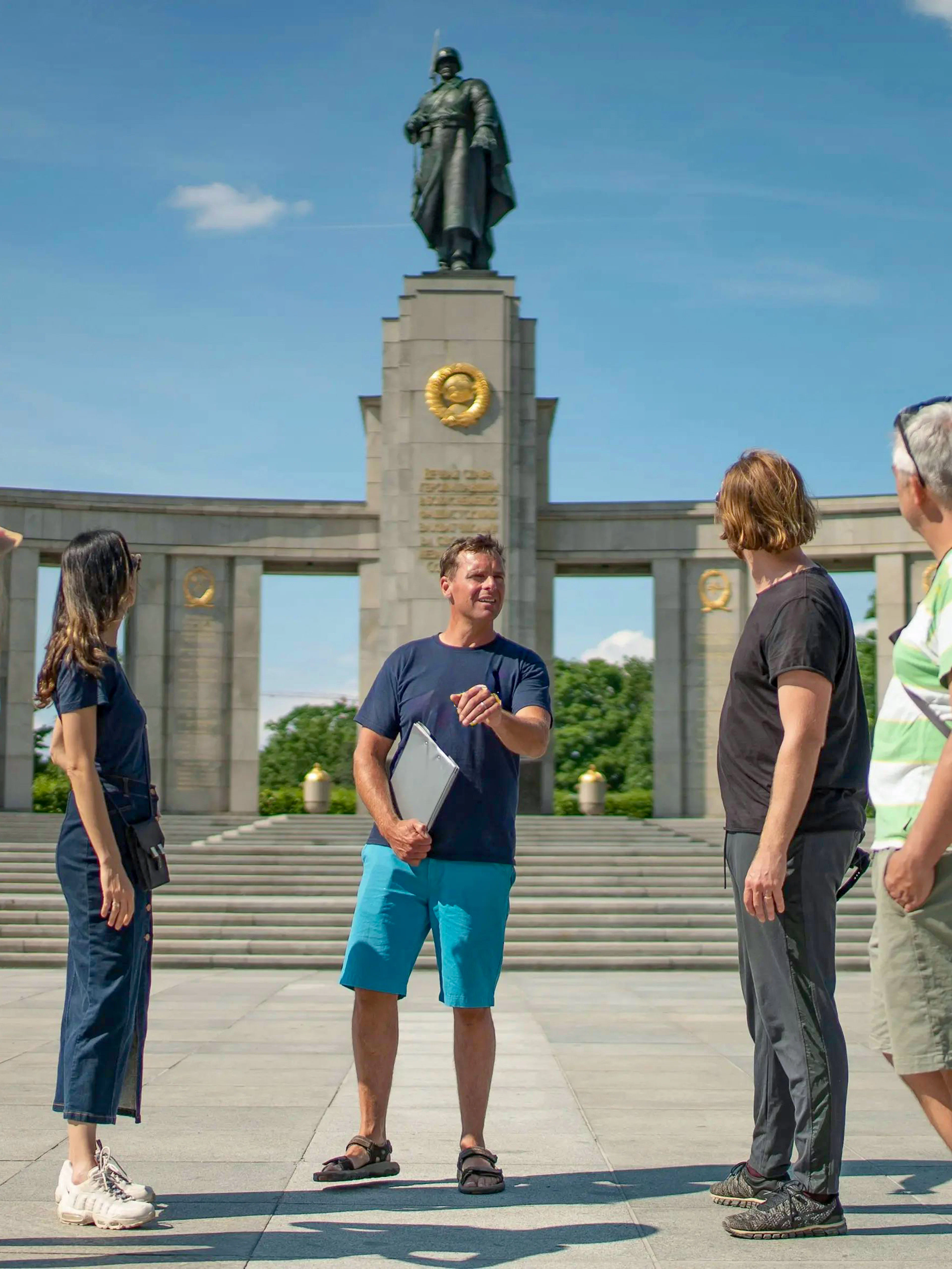 Tour group at Soviet Memorial in Tiergarten, Berlin, with guide explaining the monument.