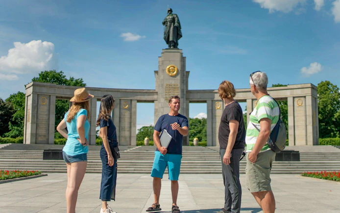Tour group at Soviet Memorial in Tiergarten, Berlin, with guide explaining the monument.