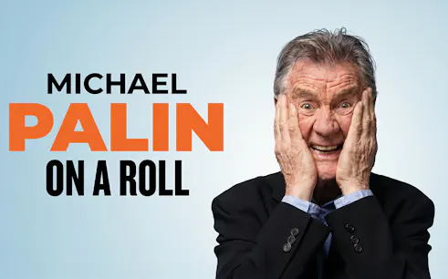 Michael Palin smiling with hands on face, text "On a Roll" beside him.