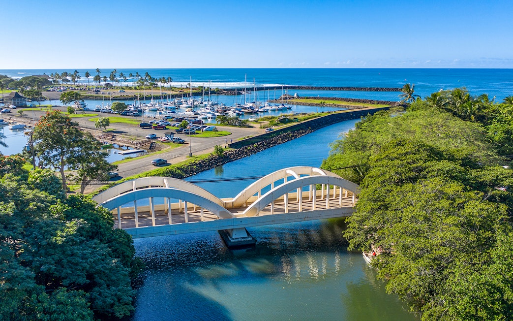 Aerial view of Haleiwa Bridge and marina on Oahu's Grand Circle Island tour.