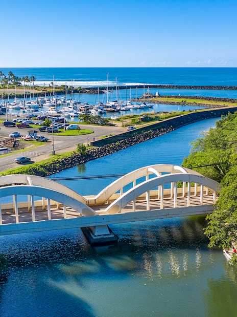 Aerial view of Haleiwa Bridge and marina on Oahu's Grand Circle Island tour.