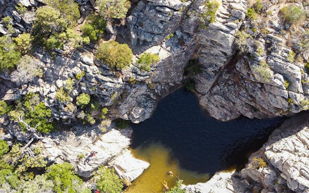 Aerial view of Rio Pitrisconi canyon with natural pool, San Teodoro Jeep Tour.