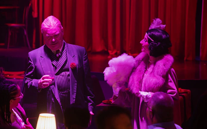 Guests in 1920s attire at a murder mystery dinner show in Buena Park speakeasy.