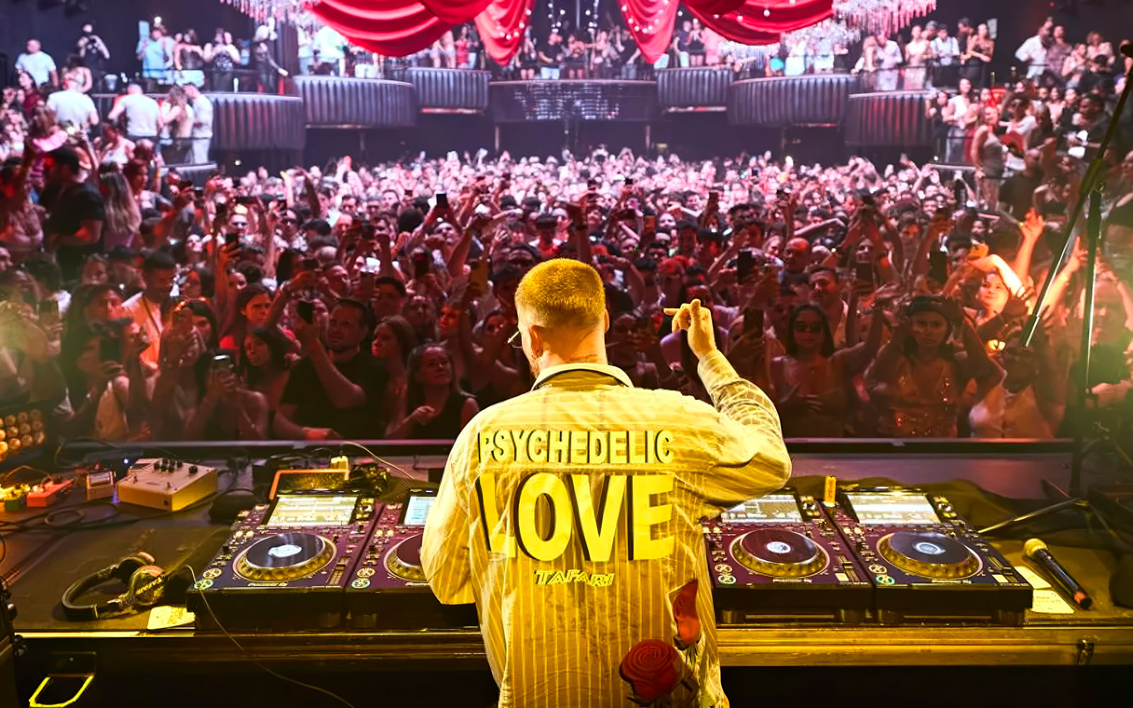 DJ performing for a lively crowd at Make the Girls Dance event, Ibiza.