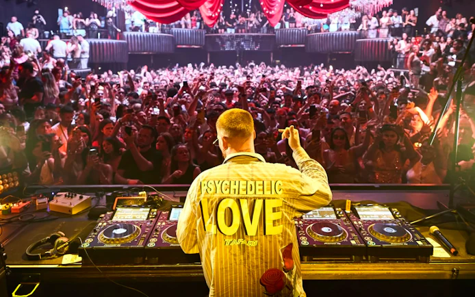 DJ performing for a lively crowd at Make the Girls Dance event, Ibiza.