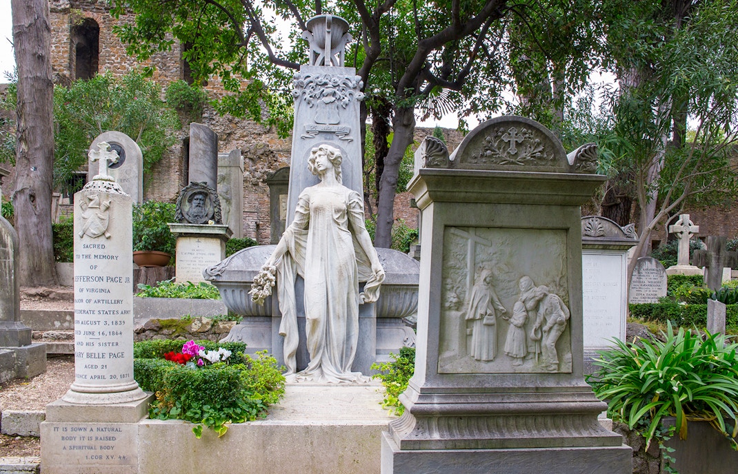 Cimitero Acattolico gravestones with lush greenery, part of Hop on Hop off Rome tour.