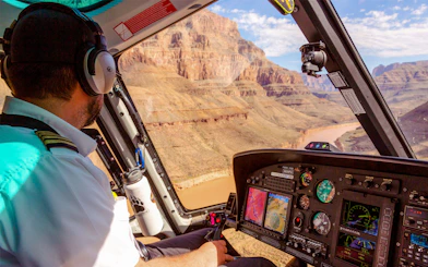 Helicopter pilot flying over Grand Canyon during Las Vegas to Grand Canyon West tour.