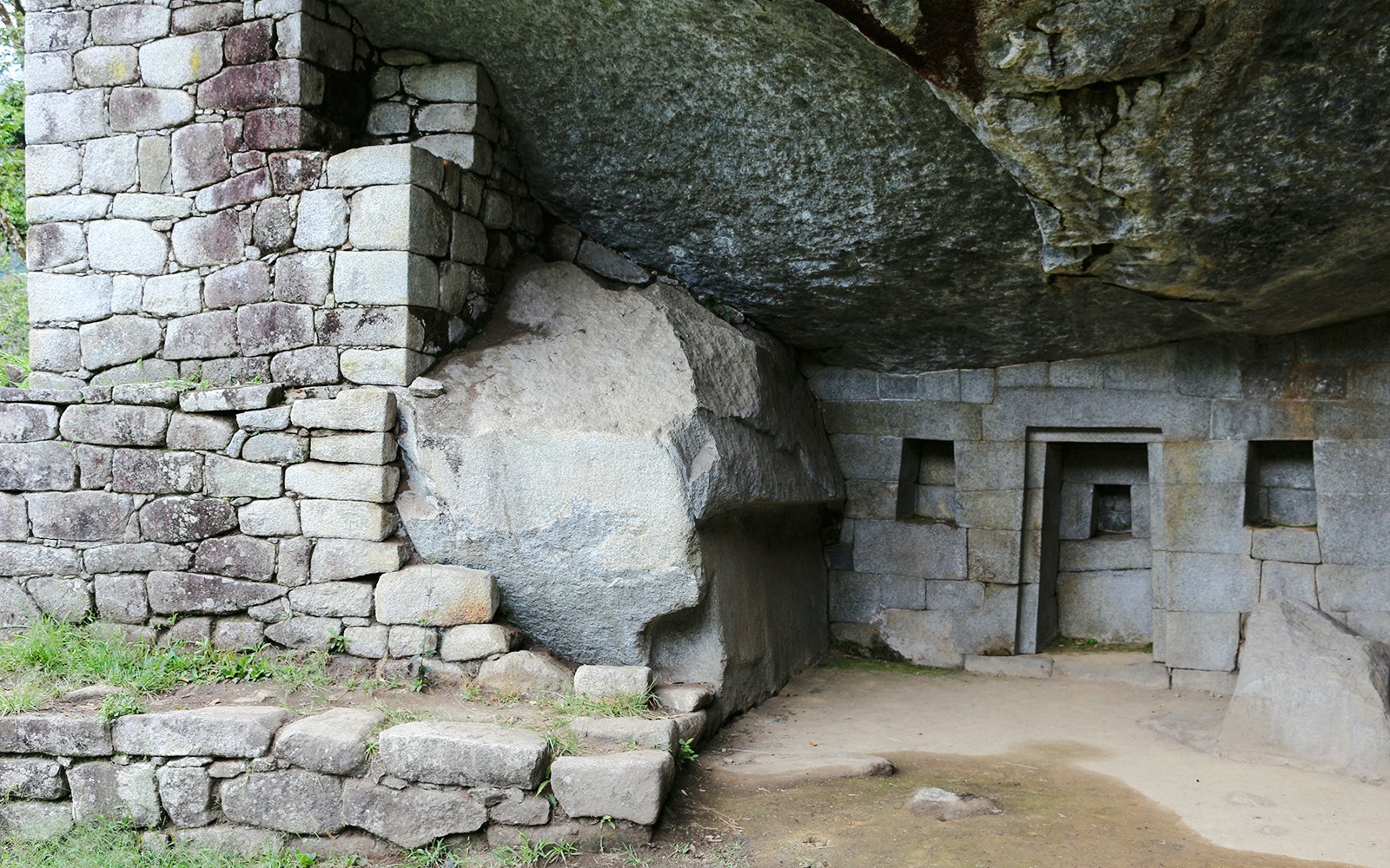 Stone structure at Moon Temple, Machu Picchu, featuring intricate masonry and carved niches.