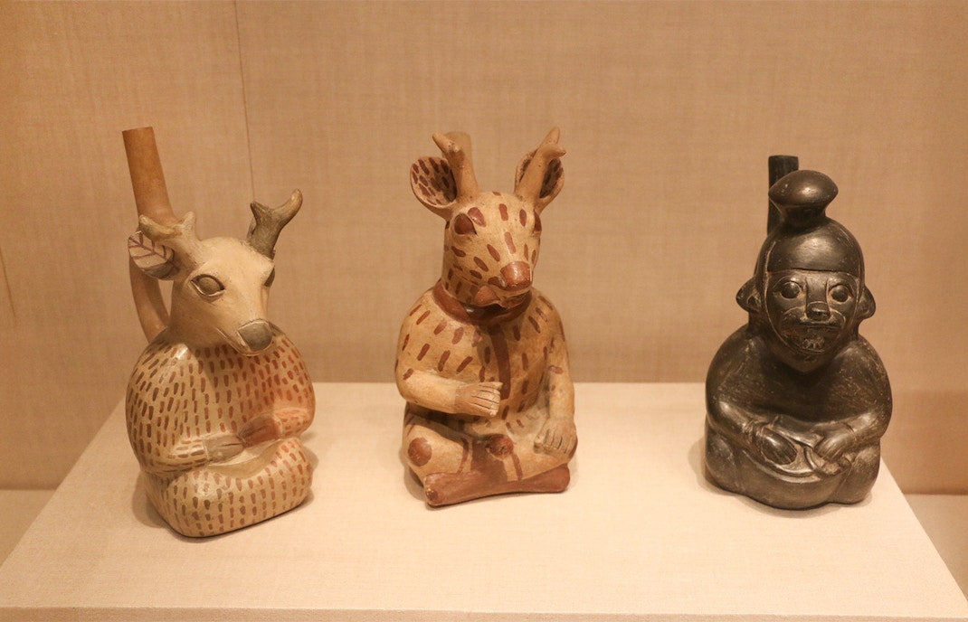 Three Moche ceramic vessels depicting animal and human forms at The Art Institute of Chicago.