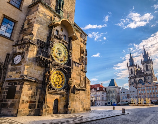 Astronomical Clock Tower in Prague with tourists viewing the historic clock face.