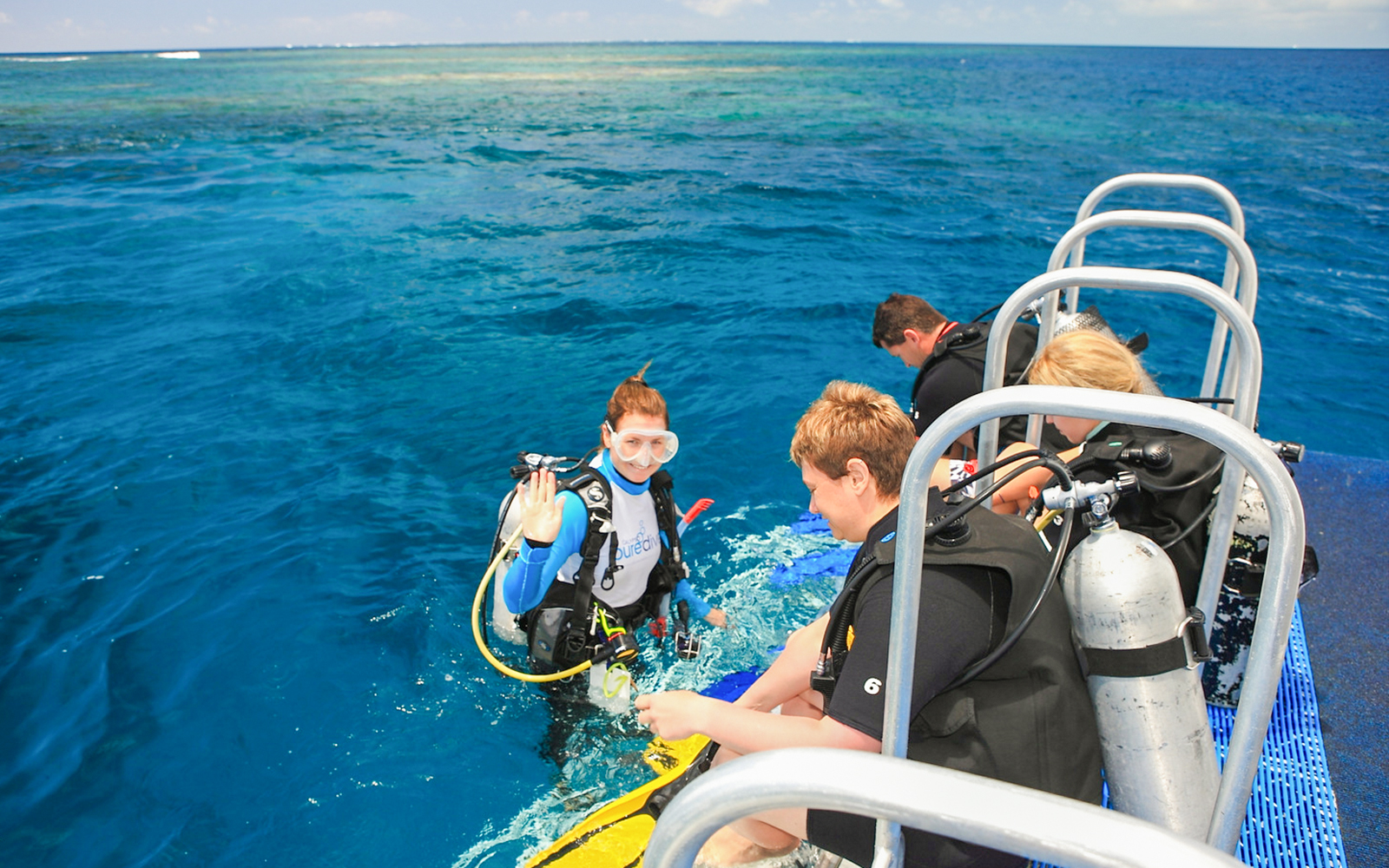 Catamaran sailing from Port Douglas to Low Isles with tourists preparing for guided snorkeling.