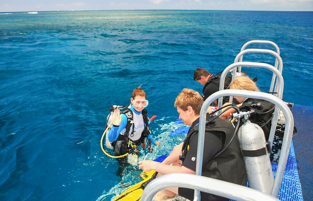 Snorkelers preparing to dive from a boat near Low Isles Island, Port Douglas.