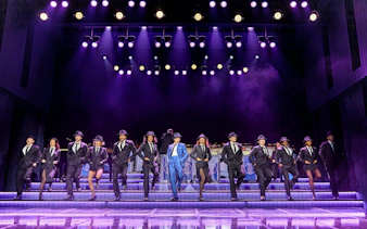 Performers in suits and hats dancing on stage in Sinatra The Musical, West End.