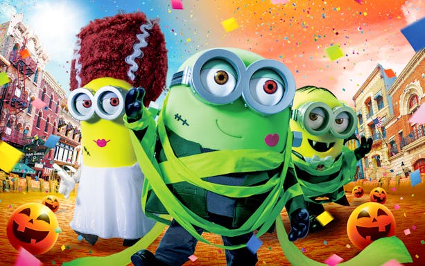 Minions in Halloween costumes at Universal Studios Japan with festive decorations.