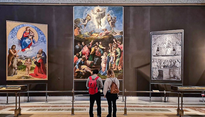 Visitors viewing Raphael's Transfiguration painting at the Vatican's Pinacoteca.