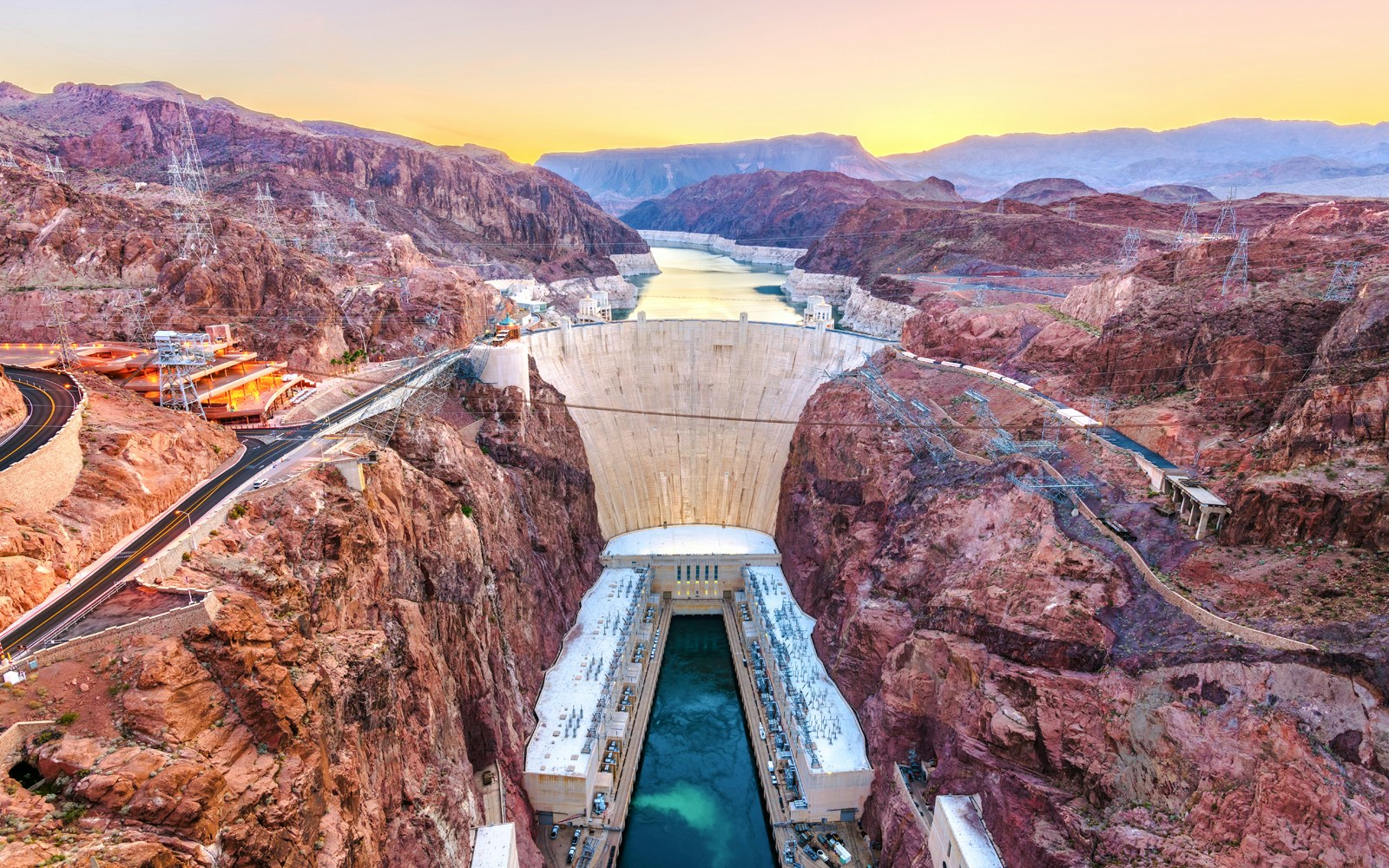 Hoover Dam spanning Colorado River at sunset, USA.