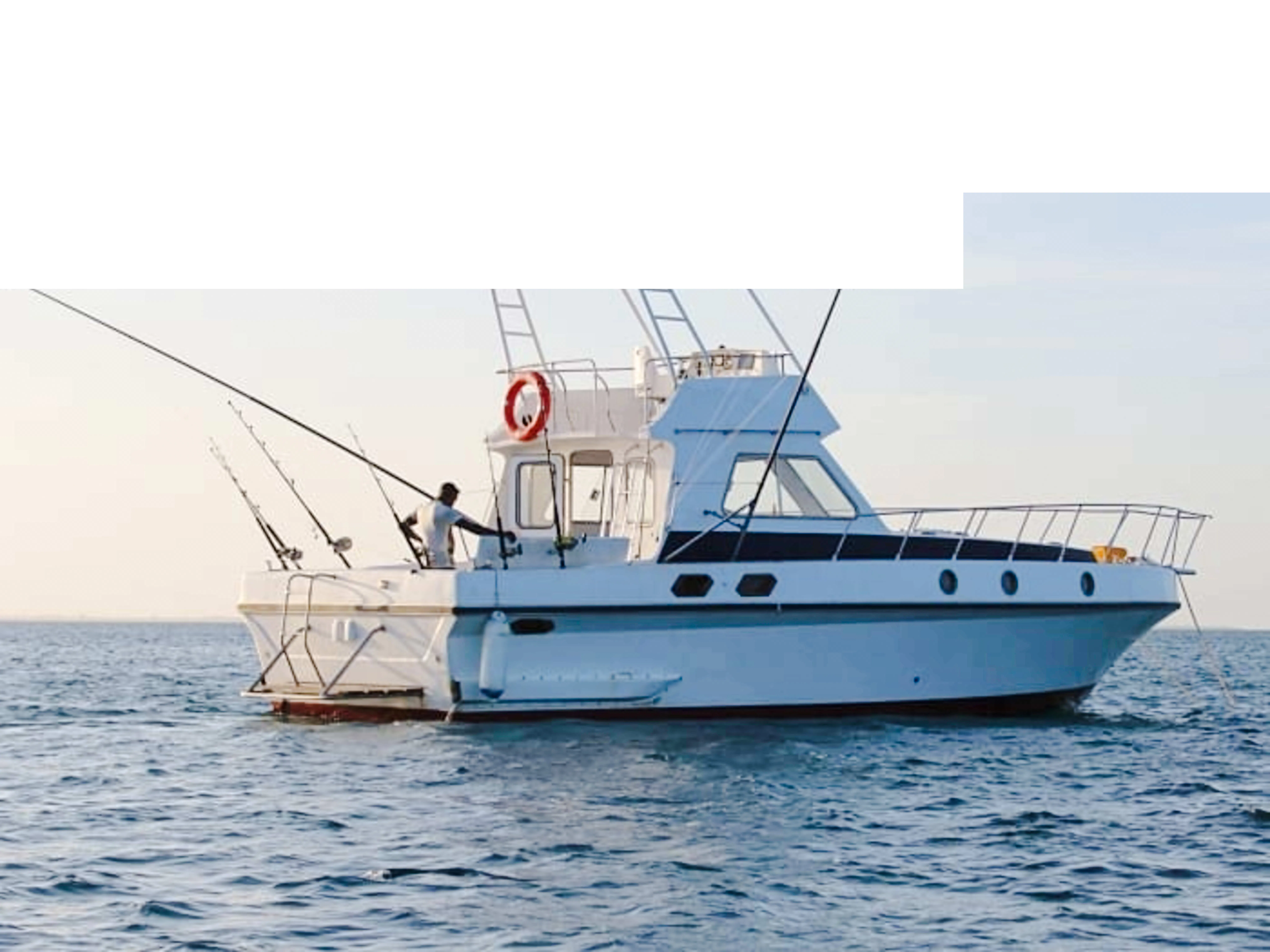 Private fishing boat with crew on deep-sea fishing charter in Zanzibar.