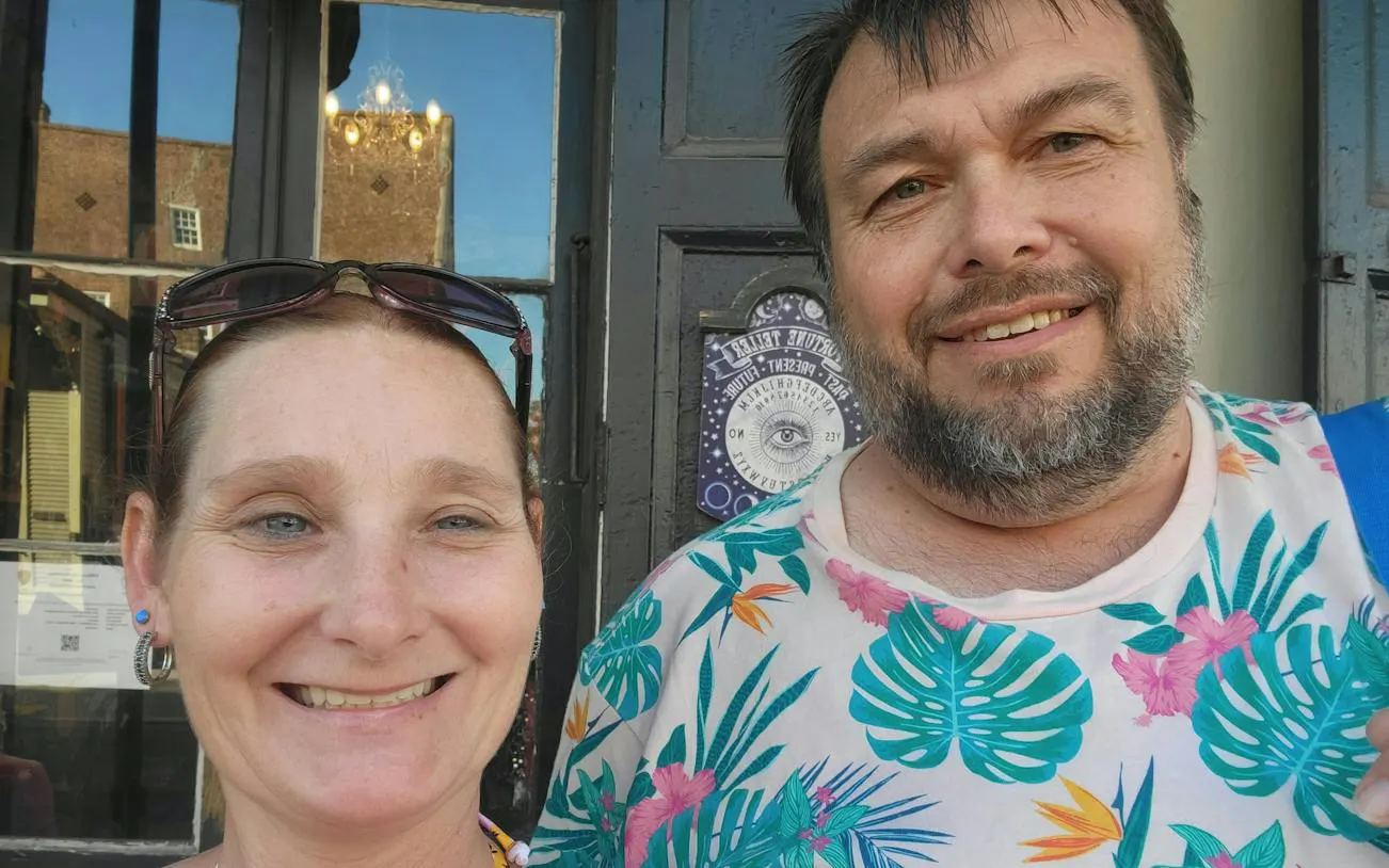Self-guided city exploration game participants in front of a New Orleans voodoo shop.