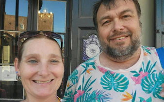 Self-guided city exploration game participants in front of a New Orleans voodoo shop.